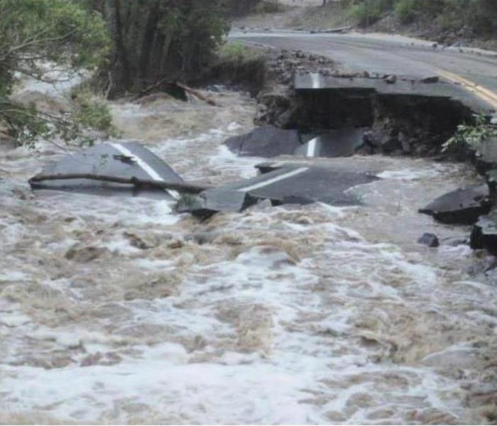 A road being washed out by a flash flood 